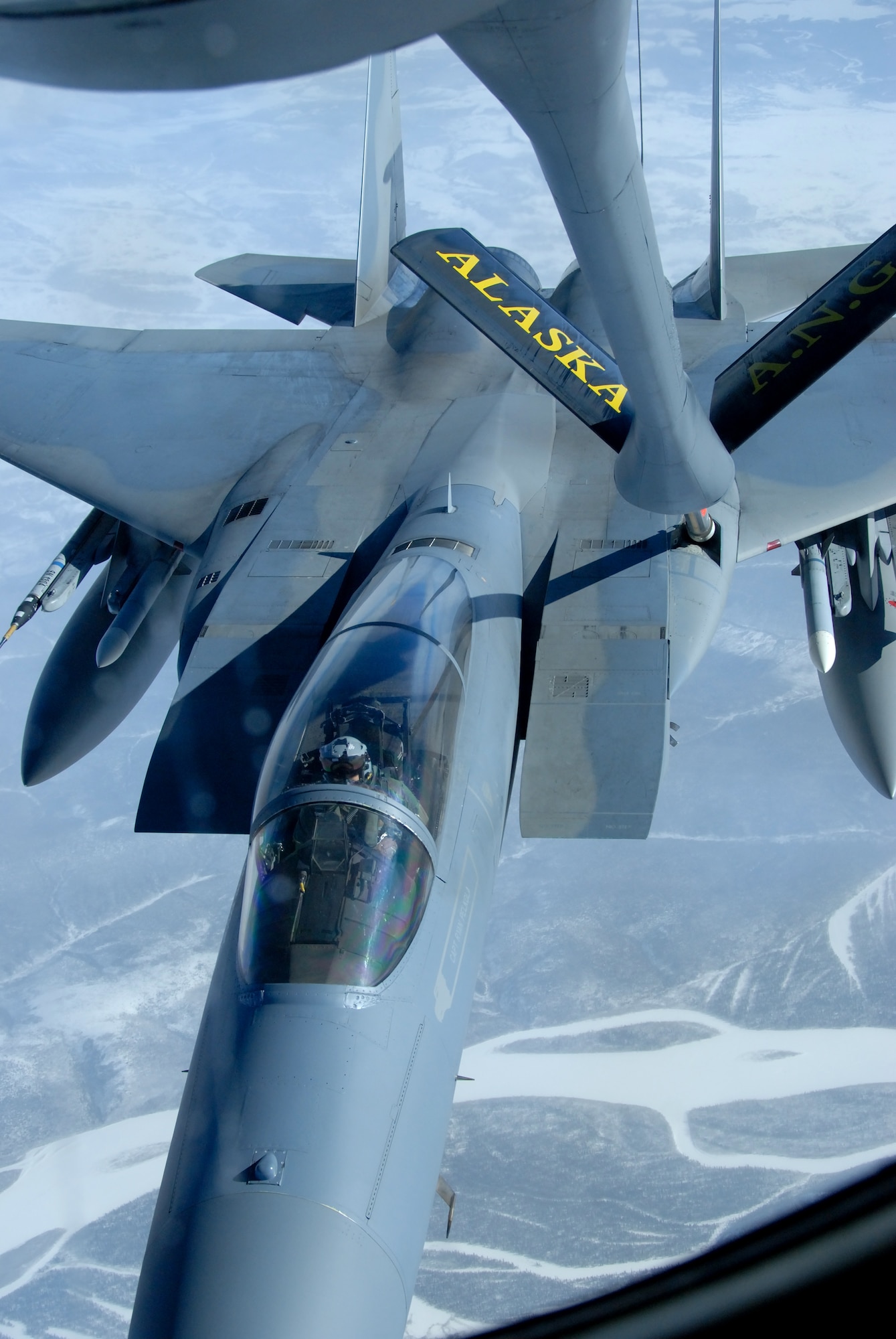 A 12th Fighter Squadron F-15 Eagle from Elmendorf Air Force Base, Alaska, receives fuel from a KC-135 Stratotanker March 26 over the Pacific Alaska Range Complex. Nearly all internal fuel, up to 200,000 pounds, can be pumped through the flying boom, the KC-135's primary fuel transfer method. The KC-135 is from the 168th Air Refueling Squadron at Eielson AFB, Alaska. (U.S. Air Force photo/Master Sgt. Robert Wieland) 
