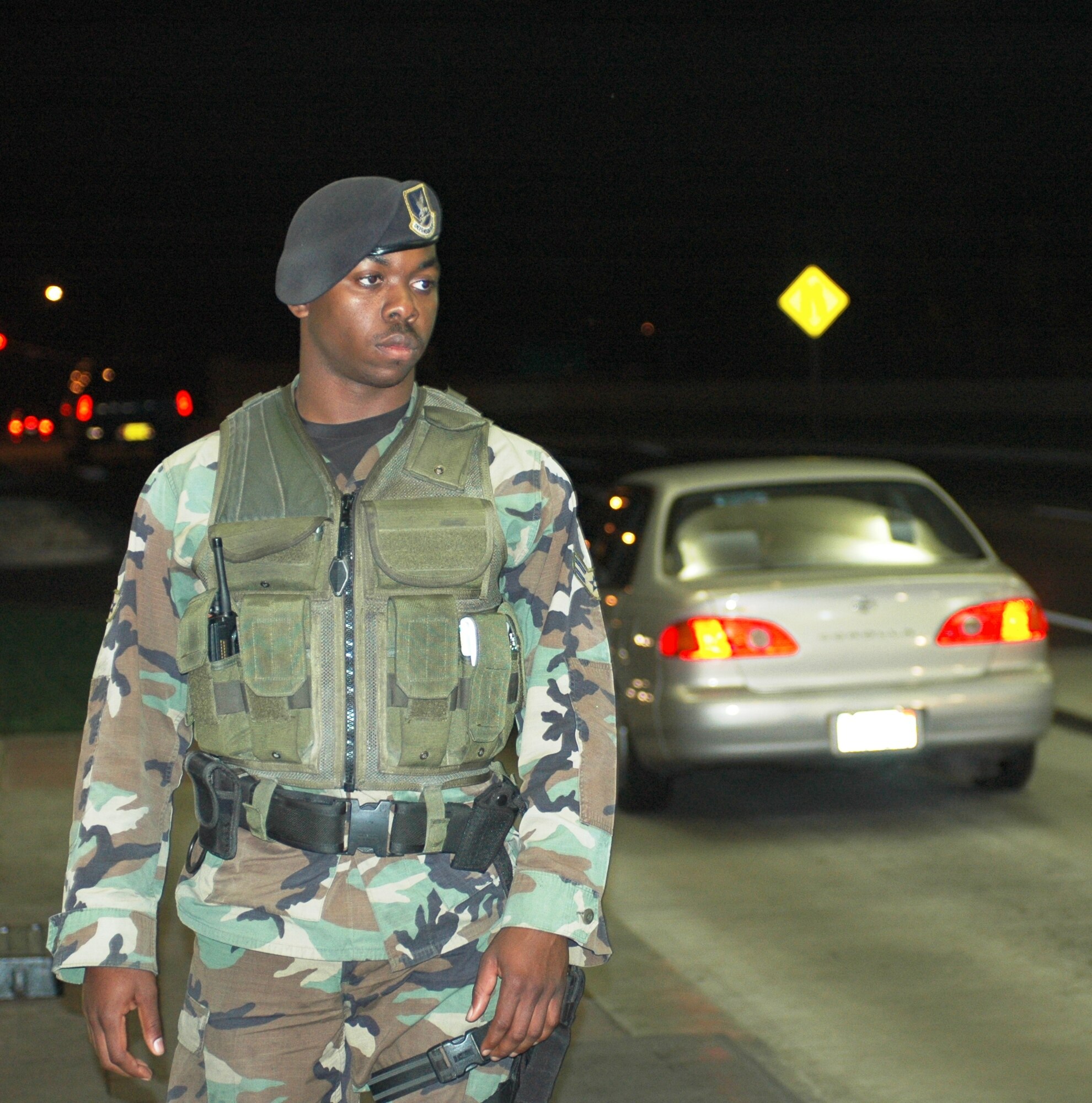 Airman 1st Class Charles Bell, 60th Security Forces Squadron, stands guard at Travis’ Main gate March 23. (U.S. Air Force photo by Tech. Sgt. Donald Osborn)

