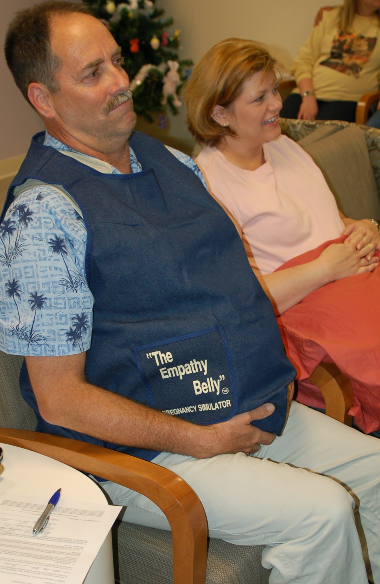 Maj. Kerry Van Orden wears an “empathy belly” to help him understand how it feels to be pregnant during the March 20 childbirth education session he attended with his wife, Capt. Stacey Van Orden.  They’re members of the 81st Medical Operations Squadron.  (U.S. Air Force Photo by Steve Pivnick)
