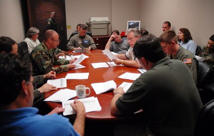 Current Operations conducts the air order of the day meeting in the 437th Operations Support Squadron conference room Wednesday. The AOD meeting brings together Airmen and civilians every day from various agencies to coordinate C-17 operations for the next three days. (U.S. Air Force photo by Senior Airman Sam Hymas)