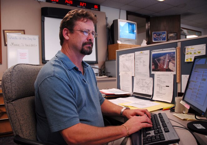 Mark Watkins, 437th Operations Support Squadron air operation specialist, works on the tactical waivers for Air Mobility Command's commander for a day mission Tuesday.