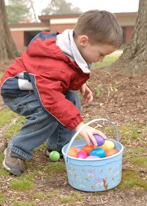 Jordan Ballard gathers his eggs during the Air Force Sergeants Association Easter egg hunt at Bethel Chapel March 24. The event is sponsored by AFSA Chapter 358 to promote community activities for the young children. (U.S. Air Force photo/Airman 1st Class Alex Nguyen)
