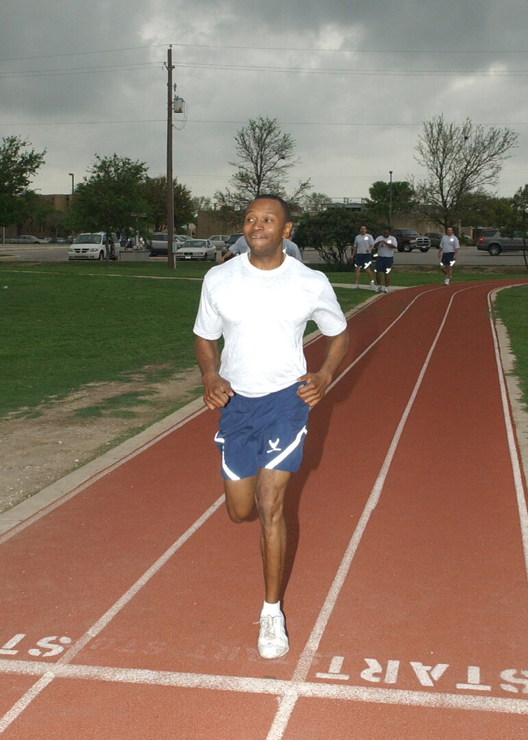 Tech. Sgt. Gernard Prince from Davis-Monthan AFB, Ariz., leads the pack during a 1.5-mile relay during the Robert D. Gaylor NCO Academy Team Challenge March 23 at the Warhawk Fitness Center on Lackland Air Force Base, Texas. Each runner of the six-member teams ran one lap, with the lowest time average winning that portion of the competition. The 15 flights of 174 NCOs competed in five events to determine which flight was the most physically fit. Flight O was the overall winner. (USAF photo by Alan Boedeker)                               