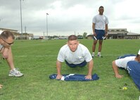 Staff Sgt. James Sailor from San Diego guts it out during the push-ups competition of the Robert D. Gaylor NCO Academy Team Challenge March 23 at the Warhawk Fitness Center on Lackland Air Force Base, Texas. Three-person teams were given one minute each to do as many push-ups and sit-ups as possible. The highest team score was 390 by Flight O. The event was one of five used to determine the most physically fit flight in the current NCOA class. (USAF photo by Alan Boedeker)                               