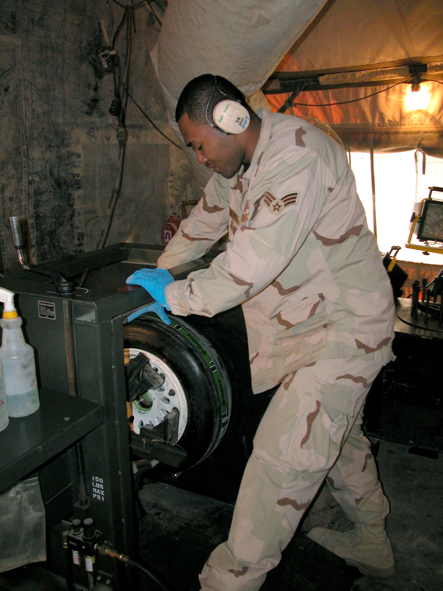 Senior Airman Jon McNairy works on an F-16 Fighting Falcon tire in the 332nd Expeditionary Maintenance Squadron's Crash Recovery, Wheel and Tire shop at Balad Air Base, Iraq.  Airmen in the shop work on about 30 wheels a week.  Airman McNairy is deployed from the 35th Maintenance Squadron, Misawa Air Base, Japan.  (U.S. Air Force photo/MSgt. Bryan Ripple)