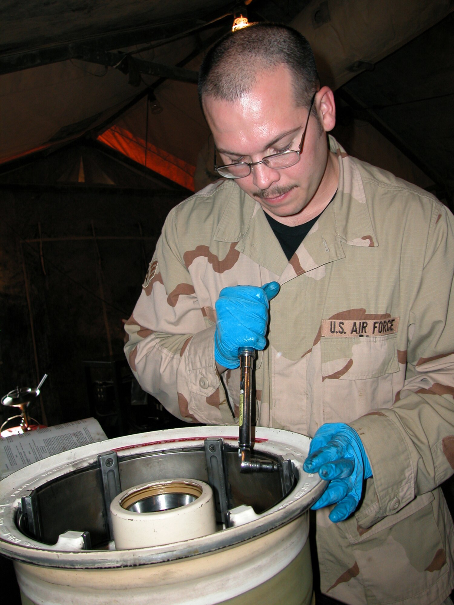 Senior Airman Samuel Shock works on an F-16 Fighting Falcon wheel March 20 in the 332nd Expeditionary Maintenance Squadron's Crash Recovery, Wheel and Tire shop at Balad Air Base, Iraq.  Airmen in the shop work on about 30 wheels a week.  Airman Shock is deployed from the 31st Maintenance Squadron, Aviano AB, Italy. (U.S. Air Force photo/Master Sgt. Bryan Ripple) 