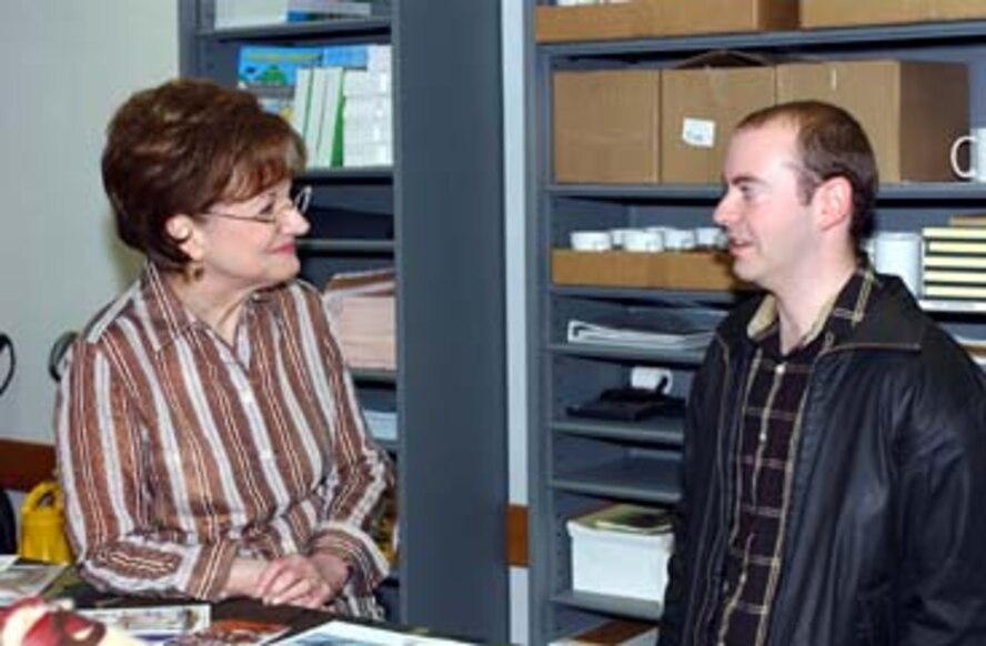Mrs. Peggy Walker, community readiness consultant, gives a tour to Mr. Raymond Chiavetta, 319th Security Forces Squadron, during an open-house event at the Airmen and Family Readiness Center here March 28.  The event, which included several base agencies, highlighted the capabilities available to base personnel and families alike. (U.S. Air Force photo/Tech. Sgt. Joseph Kapinos)