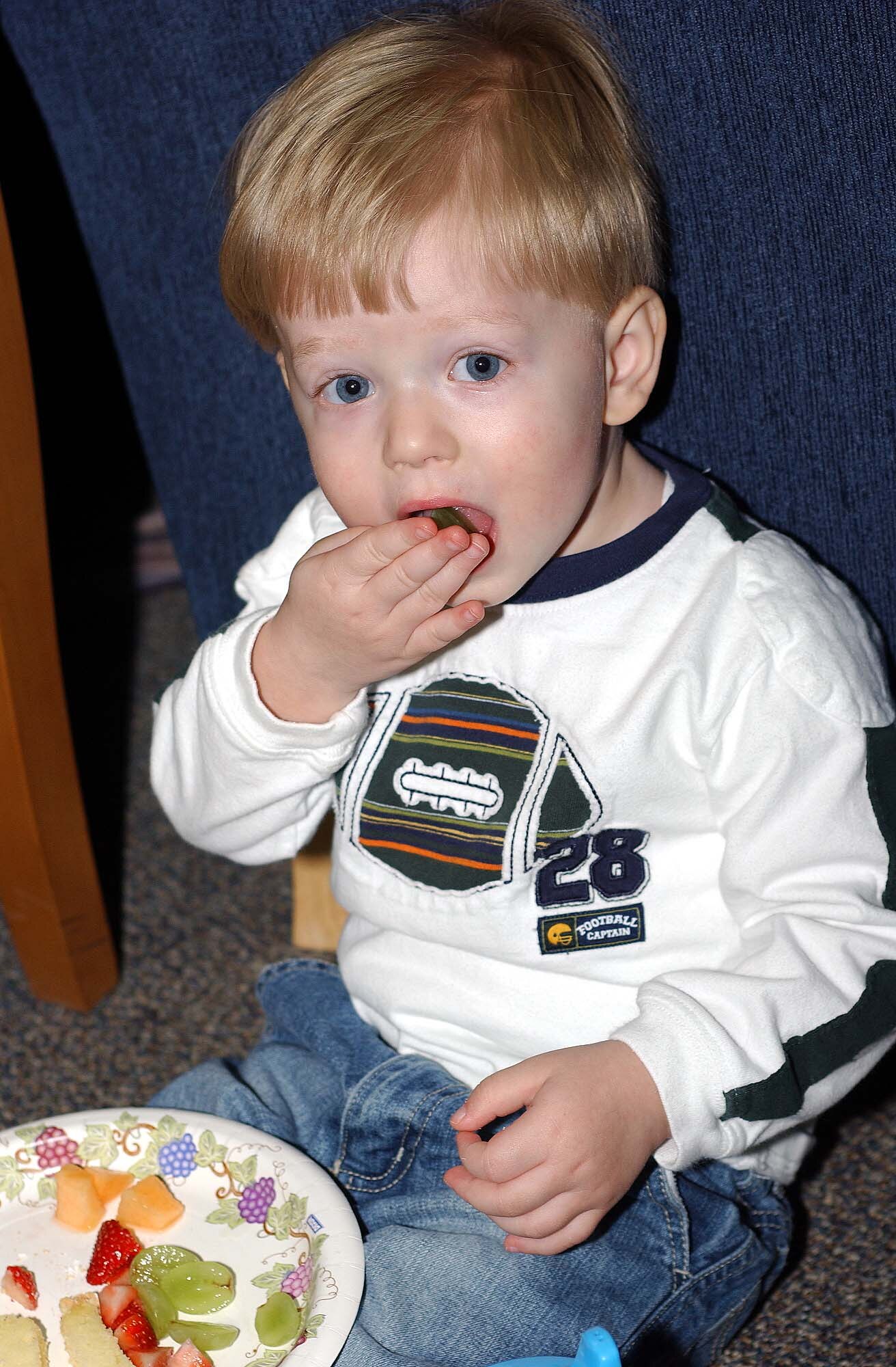 Matthew Sims, son of Capt. and Mrs. Bill Sims, 319th Area Defense Counsel, enjoys a tasty treat at an open-house event at the Airmen and Family Readiness Center here March 28.  The event, which included several base agencies educated base personnel and family members on what the center has to offer. (U.S. Air Force photo/Tech. Sgt. Joseph Kapinos)