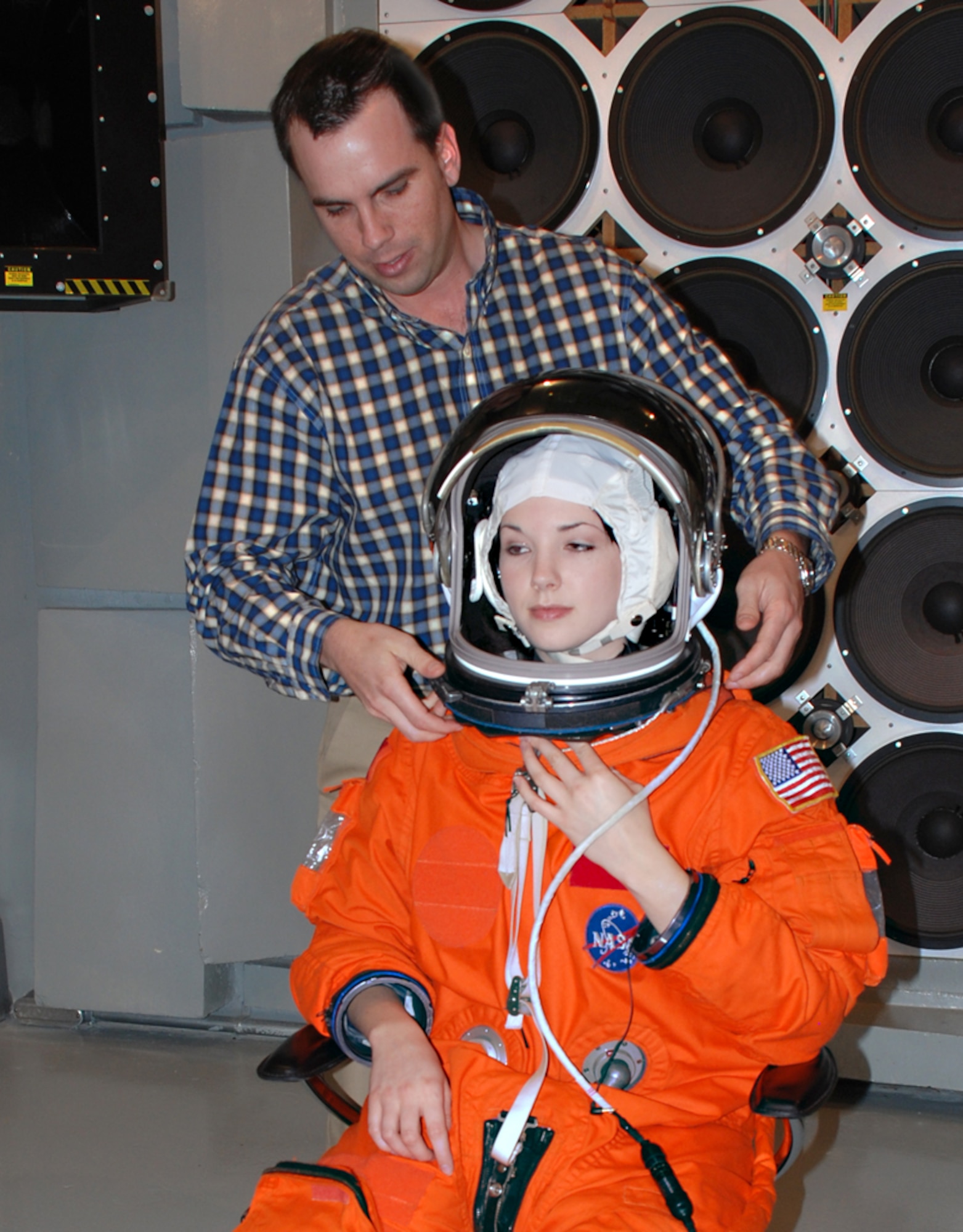 Engineer Dustin Gohmert of NASA’s Johnson Space Center locks a launch/entry helmet into place on test subject Beth Greschner of General Dynamics Advanced Information Systems. NASA and the Air Force Research Laboratory’s Human Effectiveness Directorate are testing a next-generation communications system for shuttle astronauts. (Photo by Chris Gulliford, AFRL/HE)