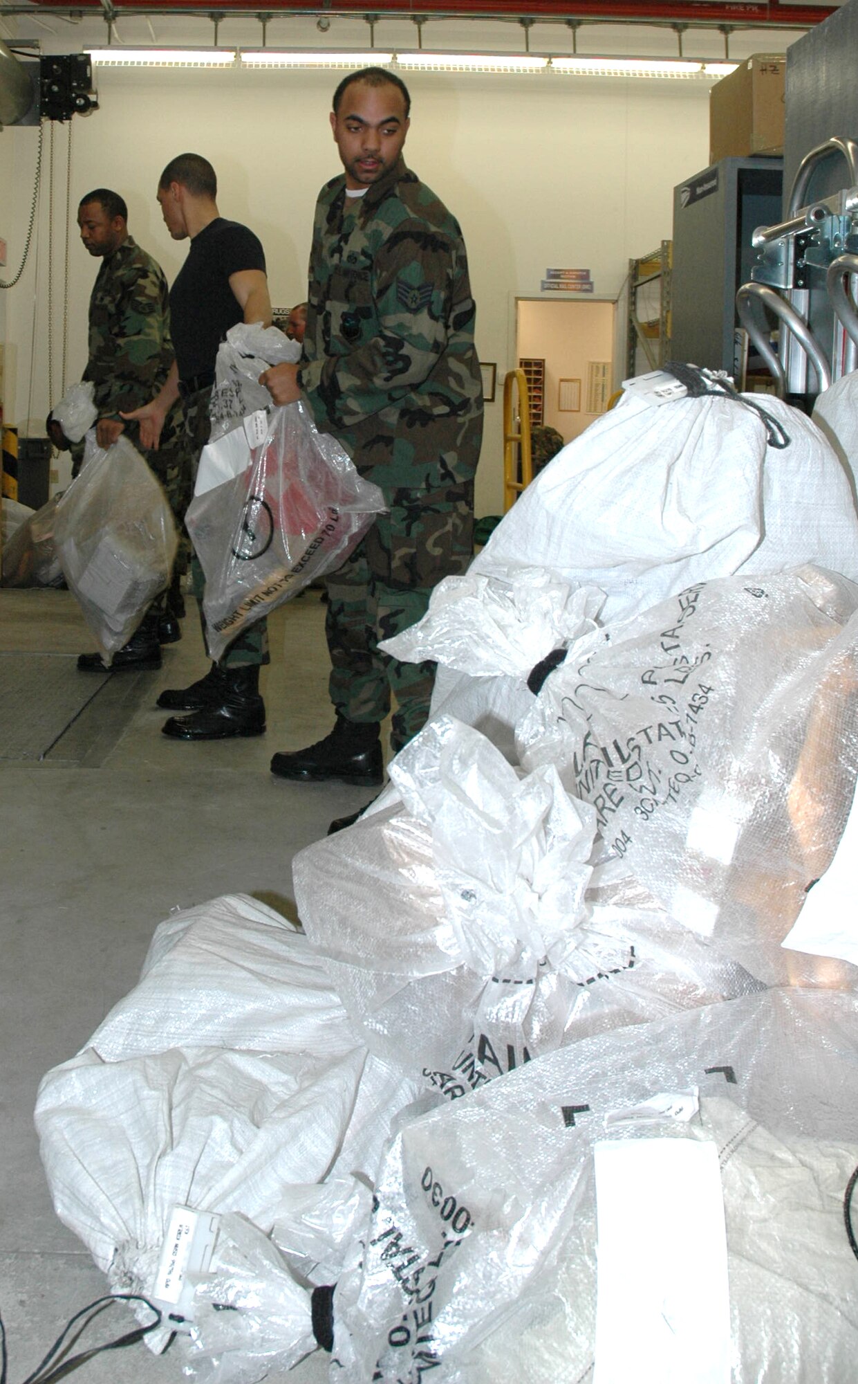 OSAN AIR BASE, Republic of Korea --  Staff Sgt. Donnell Sanseverino, 51st Civil Engineer Squadron, is the last of a 10-person human chain used to expeditiously off-load an incoming mail truck here March 21 so the truck could make its next delivery. The mail arrived from Incheon International Airport. (U.S. Air Force photo by Tech. Sgt. Michael O’Connor)