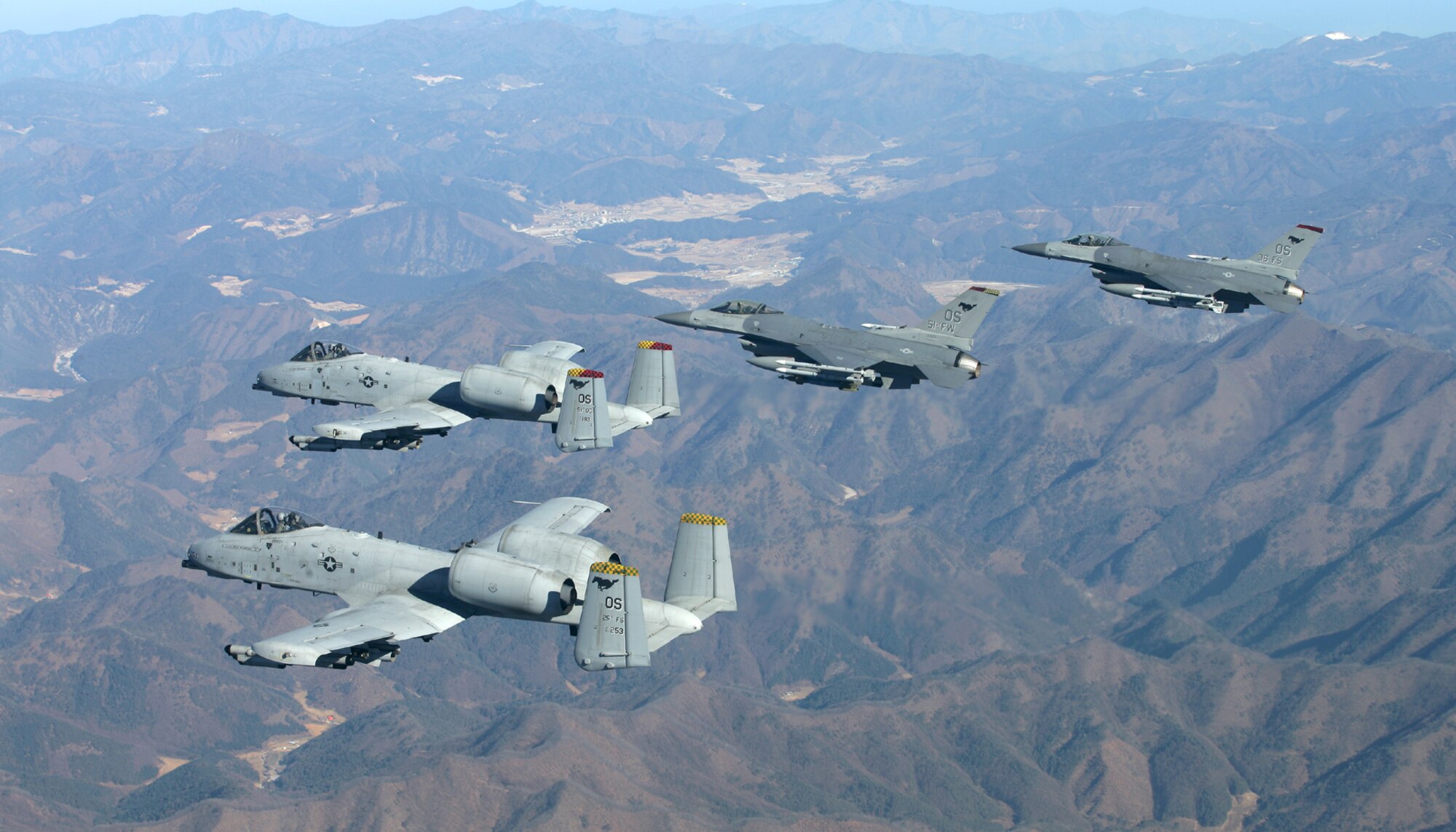 OSAN AIR BASE, Republic of Korea --  Two A-10 Thunderbolt IIs from the 25th Fighter Squadron and two F-16 Fighting Falcons from the 36th Fighter Squadron fly over the Republic of Korea in formation recently. The 51st Fighter Wing hosted the RSO&I and Foal Eagle exercises here. (Photo by Jim Haseltine)