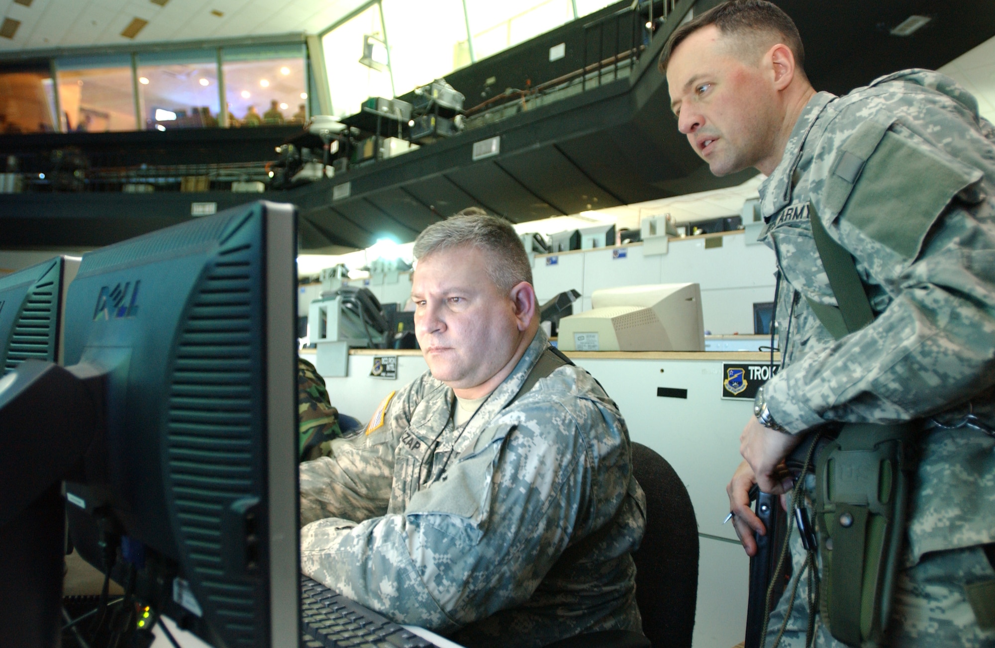 OSAN AIR BASE, Republic of Korea --  Lt. Col. Philip McCutcheon, 3rd Battlefield Coordination Detachment deputy commander, and Sgt. 1st Class Wessley Czap, 3rd BCD operations NCO, analyze incoming data on the computer monitor during RSO&I on Monday. (U.S. Air Force photo by Staff Sgt. Francisco V. Govea II)