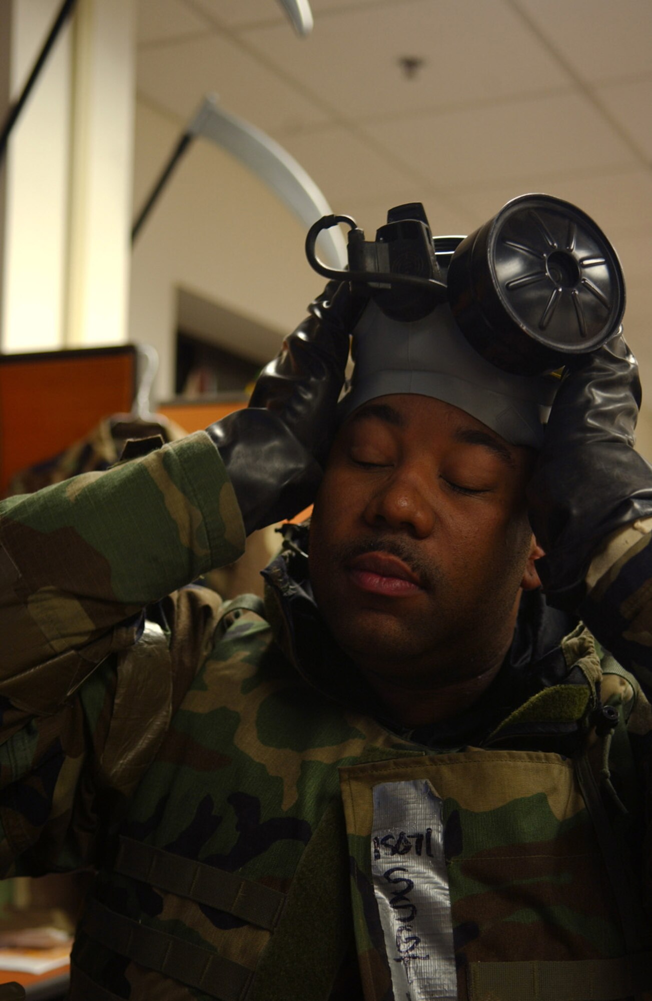 OSAN AIR BASE, Republic of Korea --  Staff Sgt. Malcolm Logan, 51st Fighter Wing ground safety technician, removes his gas mask after a "missile attack" Monday during the most recent exercise here. (U.S. Air Force photo by Staff Sgt. Ronnie Hill)