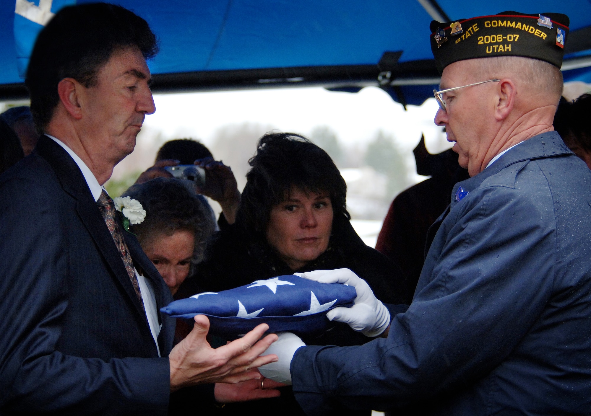 Terry J. Nielsen accepts the traditional folded flag from Utah's Veterans of Foreign War state commander during the interment service for his father Lt. Col. Chase J. Nielsen March 28. Colonel Nielsen was one of the few remaining members of the famed Doolittle Raiders. The members of the Doolittle Raiders reached national acclaim in 1942 after launching the first successful aerial bombing raid on Tokyo, Japan as retaliation for the Japanese bombing of Pearl Harbor, Hawaii in December of 1941. (U.S. Air Force photo/Efrain Gonzalez)