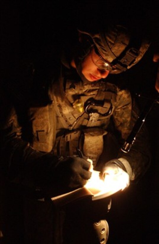 U.S. Army Sgt. Jeremiah Grubb sketches the outline of a room during a raid in Adhamiya, Iraq, on March 25, 2007.  Grubb is attached to Charlie Company, 1st Battalion, 26th Infantry Regiment, 3rd Brigade Combat Team, 1st Infantry Division.  