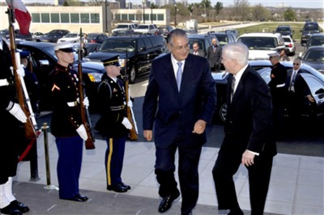 Secretary of Defense Robert M. Gates, right, talks with Peruvian Minister of Defense Allan Wagner, left, as they walk through a cordon on honor guards and into the Pentagon on March 29, 2007.  The two defense leaders will hold bilateral security discussions on a variety of global and regional issues of interest to both governments.