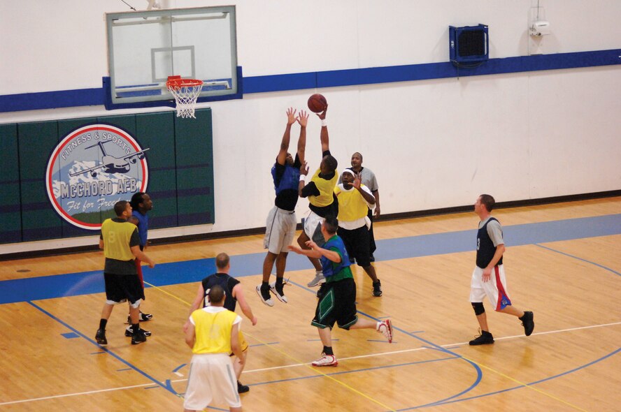 MCCHORD AIR FORCE BASE, Wash. -- The 62nd Aircraft Maintenance Squadron attempts to score against the 62nd Services Squadron Monday during opening day of the intramural basketball playoffs at the base fitness center. The intramural basketball championship game will be at 6 p.m. tonight at the fitness center. (U.S. Air Force photo/Abner Guzman)
