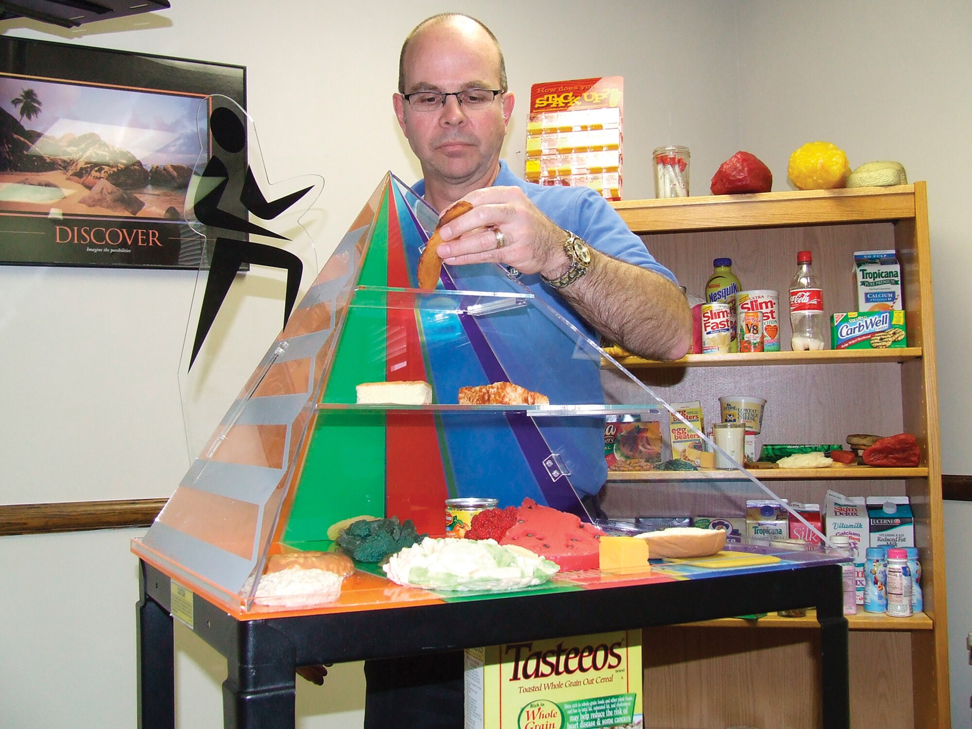 Brent Carney, 62nd Medical Operations Squadron, adjusts a food pyramid display at the Health and Wellness Center Tuesday.  Mr. Carney, the new base dietician, has been a dietician for 18 years. (U.S. Air Force Photo/Tyler Hemstreet)