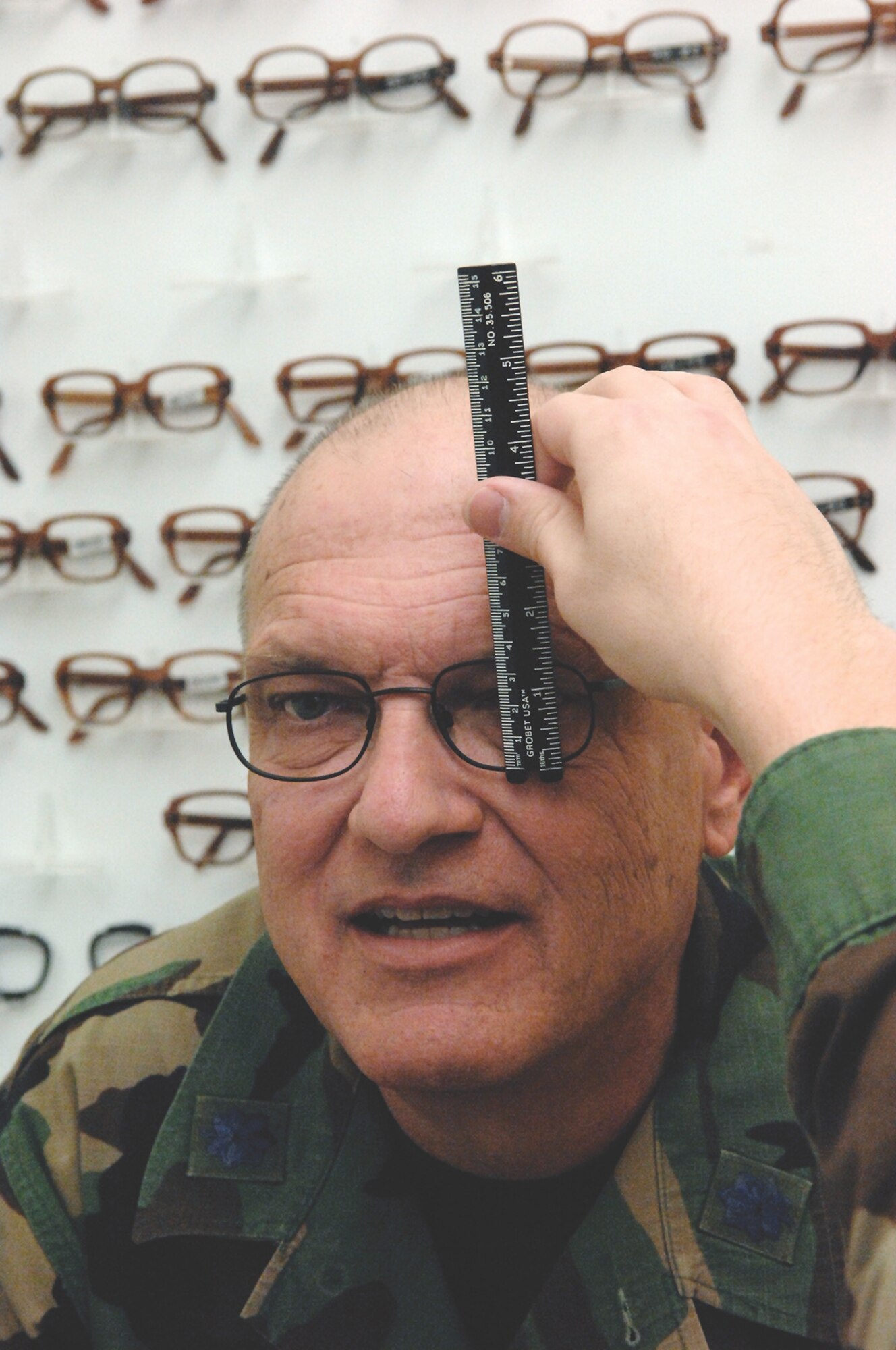 MCCHORD AIR FORCE BASE, Wash. -- Chaplain Lt. Col Michael Lovett, 62nd Airlift Wing,  gets fitted for new bifocals with a segment height-measuring gauge by an optometry technician.for new bifocals during a visit to the Optometry clinic March 15, 2007. (U.S. Air Force photo/Abner Guzman)