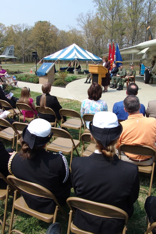 (Left to right) Navy JROTC Cadet Lieutenant Commander Amber Stocks and Cadet Seaman Apprentice Jane Luca listen to retired Navy Capt. Rosemary Mariner, the first military woman to command an operational fleet squadron, speak at Arnold Air Force Base., Tenn., March 30 at the F-14 Tomcat Dedication Ceremony in honor of the late Lt. Kara Hultgreen. Lt. Hultgreen was the Navy’s first female carrier-based combat fighter pilot who was killed in a crash in October 1994 in the F-14 she was piloting. (Photo by Joel Fortner)