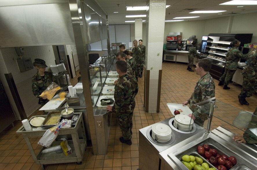 Airman Julia Morisoli, 23rd Services Squadron, (far left) fills the cheese container during the morning breakfast rush at Moody's Dining Facility March 30. Contractors and Airmen have been working to update much of the facility's infrastructure for the past two months.The main improvement involves the serving line; previously made of wood, it was replaced with stainless steel for sanitation reasons. (U.S Air Force photo by Staff Sgt. Manuel J. Martinez)
