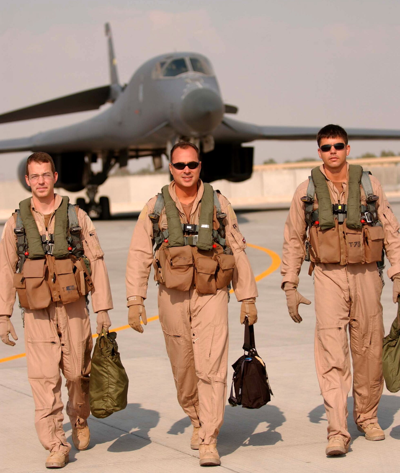 After flying a 12-hour nighttime close-air-support mission over Afghanistan recently, Capt. Craig Morrison, Maj. Mike Jason and Capt. David Grasso (left to right) walk from a B-1B Lancer in Southwest Asia. The weapon systems officer, aircraft commander and co-pilot are assigned to the 37th Expeditionary Bomb Squadron, part of the 379th Air Expeditionary Wing in Southwest Asia. (U.S. Air Force photo/Ricky Best)