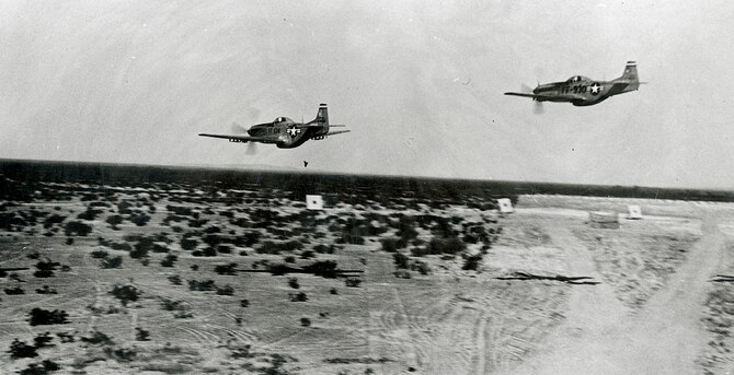 Two U.S. P-51 Mustangs conduct a low strafing pass over the Arizona desert at what is now the Barry M. Goldwater Range. (Courtesy photo)