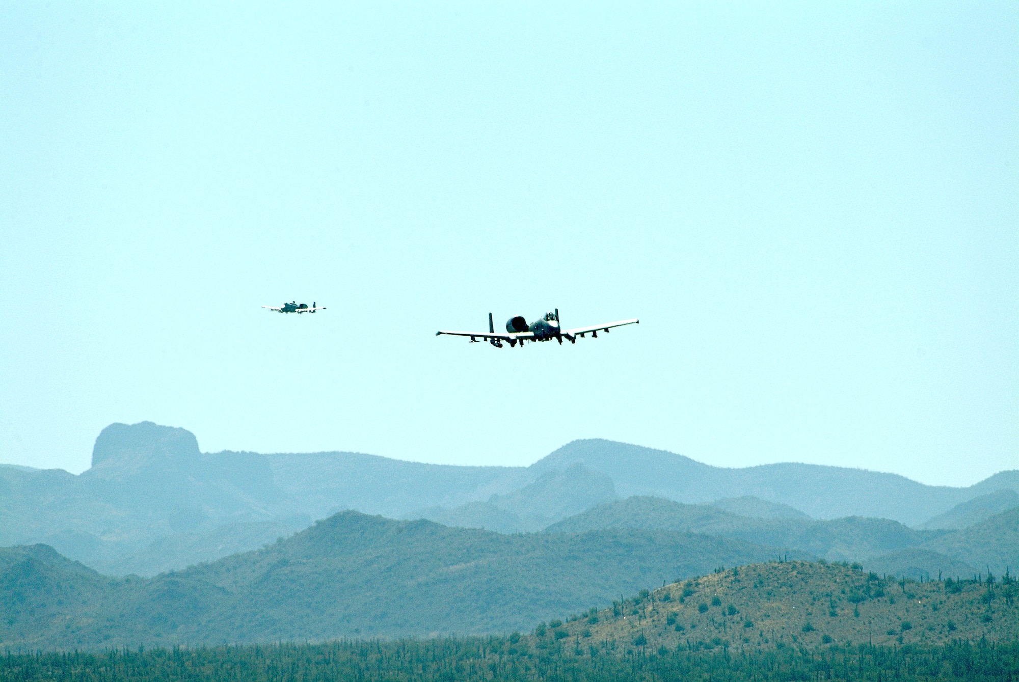 Two Air Force Reserve Command A-10 Thunderbolt IIs from the 442nd Fighter Wing based at Whiteman Air Force Base, Mo., maneuver over the Barry M. Goldwater Range, Ariz., during live-fire training Feb. 26, 2007. (U.S. Air Force photo/Master Sgt. William Huntington)