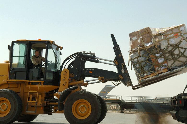 Air transportation specialist Airman 1st Class Brenten Chrans uses a 10K adverse terrain forklift to download cargo from a 60K aircraft loader for in processing March 14 at Balad Air Base in Iraq. Airman Chrans is with the 332nd Expeditionary Logistics Readiness Squadron Aerial Port Flight. (U.S. Air Force photo/Airman 1st Class Nathan Doza) 