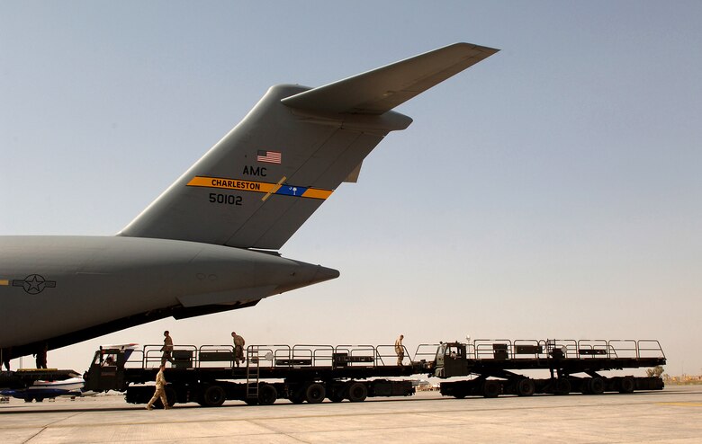 Airmen with the 332nd Expeditionary Logistics Readiness Squadron Aerial Port Flight prepare to in process cargo from a C-17 Globemaster III March 14 at Balad Air Base in Iraq. Balad AB is the aerial port hub for all of Iraq and is the busiest cargo aerial port in the Department of Defense. (U.S. Air Force photo/Airman 1st Class Nathan Doza) 