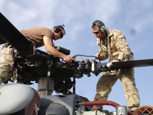 Rescue Wing Reservists SrA Ron Arroyo, and Tech Sgt. Dean Peterson, both helicopter maintenance crew chiefs with the 920th Maintenance Squadron service a rotor blade dampiner on an HH-60G Pave Hawk helicopter during a preflight inspection while deployed to Afghanistan as part of an Air Force Aerospace Expeditionary Force rotation. The 920th Rescue Wing‘s primary mission is to provide combat search and rescue operations anywhere in the world as directed. 

