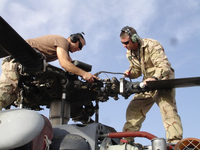 Rescue Wing Reservists SrA Ron Arroyo, and Tech Sgt. Dean Peterson, both helicopter maintenance crew chiefs with the 920th Maintenance Squadron service a rotor blade dampiner on an HH-60G Pave Hawk helicopter during a preflight inspection while deployed to Afghanistan as part of an Air Force Aerospace Expeditionary Force rotation. The 920th Rescue Wing‘s primary mission is to provide combat search and rescue operations anywhere in the world as directed. 
