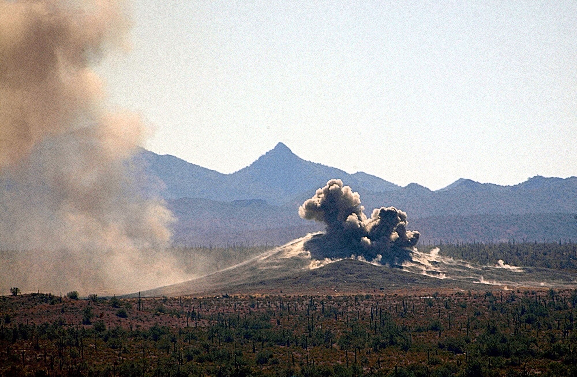 Erupting like a small volcano, a 500-pound Mark-82 bomb dropped by an Air Force Reserve Command A-10 Thunderbolt II from the 303rd Fighter Squadron, hits it target at High Explosive Hill on the Barry M. Goldwater Range, Ariz. The Whiteman Air Force Base, Mo., reservists from the 442nd Fighter Wing were using the range for live ordnance training while temporarily based at Arizona's Davis-Monthan A.F.B. near Tucson. (U.S. Air Force photo/Master Sgt. Bill Huntington)