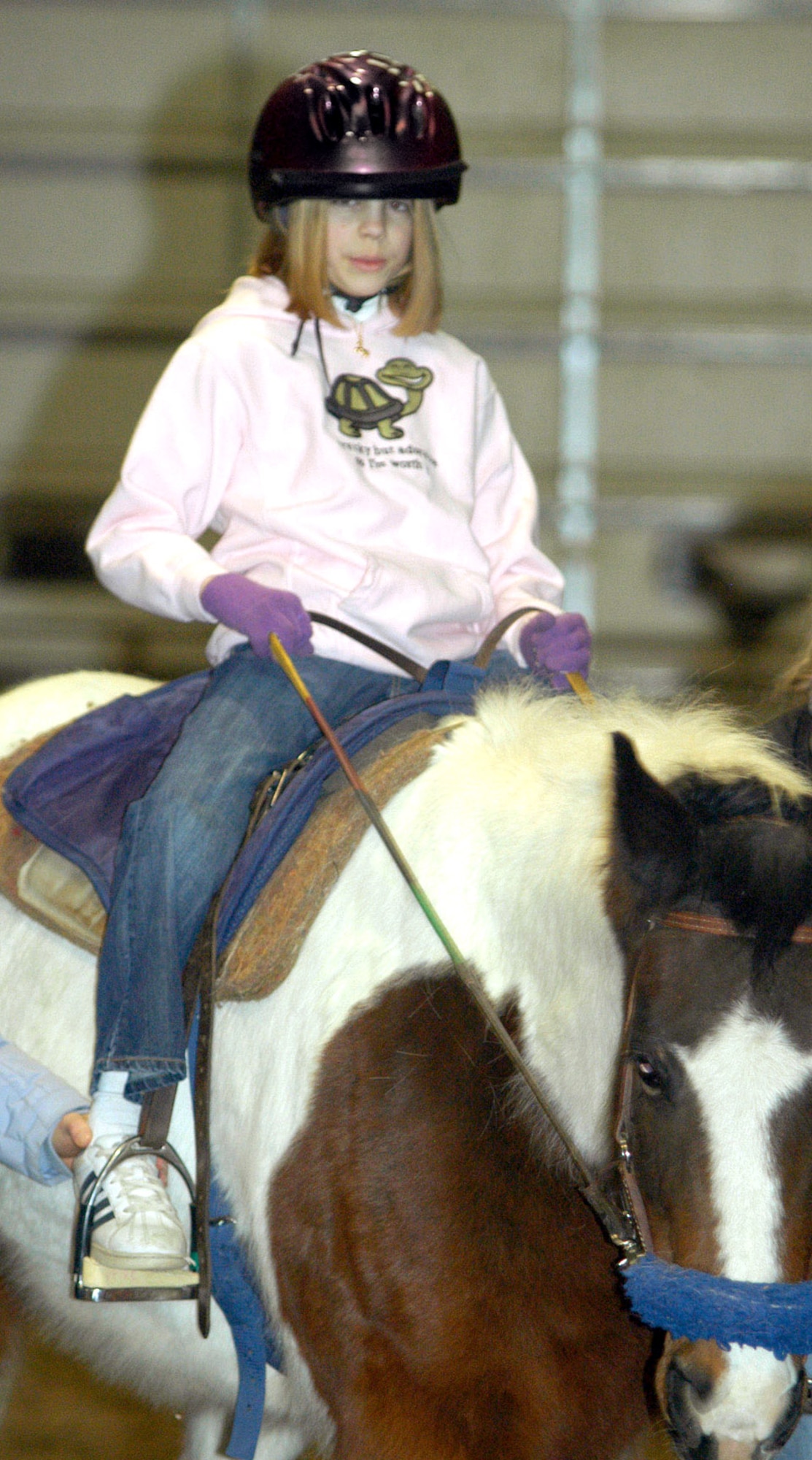 Erin Pelton, age 13, rides a horse during a weekly therapy session at Pikes Peak Therapeutic Riding Center in Colorado Springs, Colo. Erin has dystonic cerebral palsy, a neurological disorder. The therapy helps encourage independence and has helped Erin walk, as her left foot tends to roll inward and her right foot drags. (U.S. Air Force photo/Staff Sgt. Amanda Delisle)