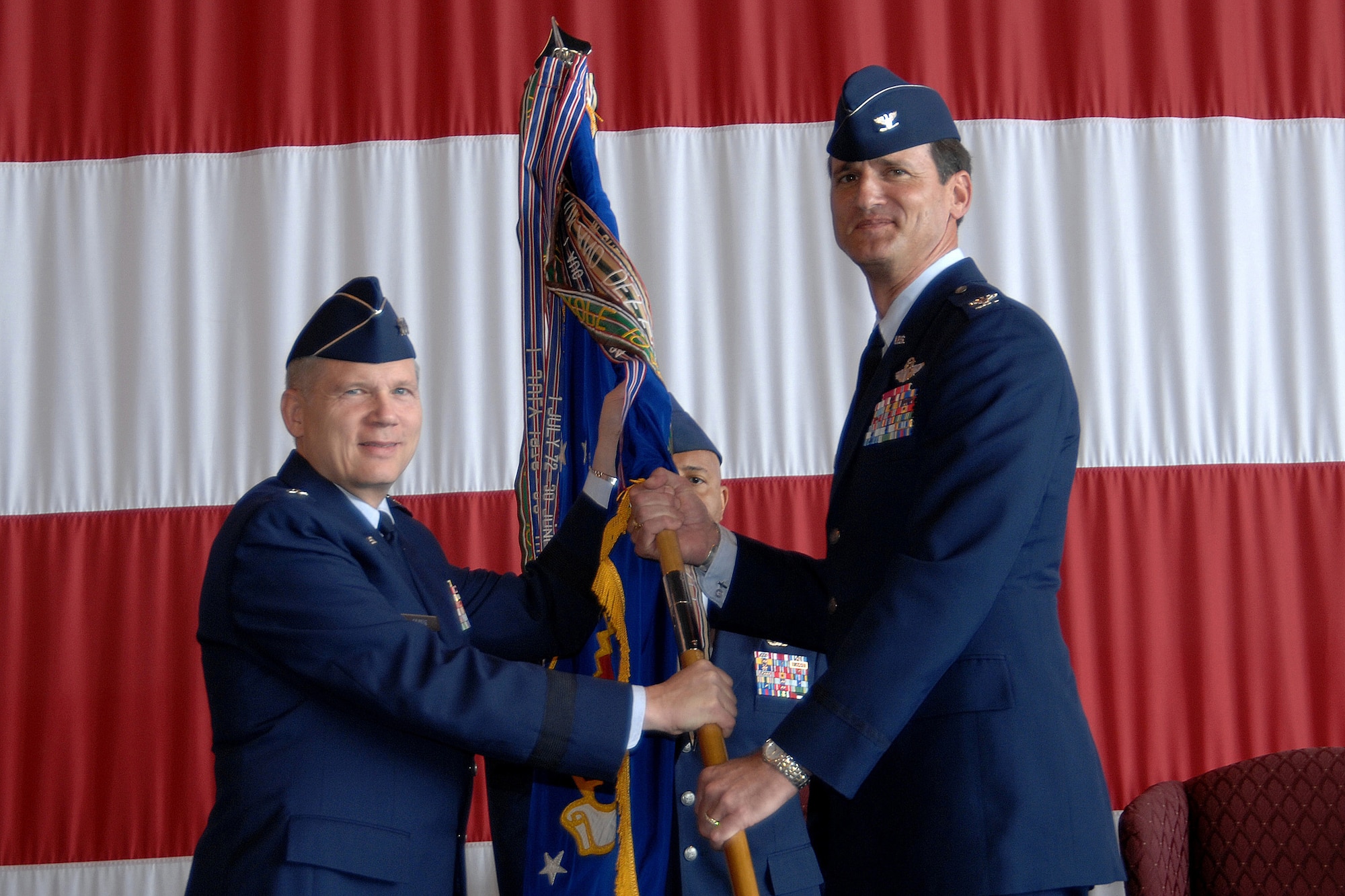 OFFUTT AIR FORCE BASE, Neb. -- The new 55th Wing Commander Colonel Jim Jones (right) accepts the wing’s guidon from Eighth Air Force Commander Lt. Gen. Robert Elder Jr. during a wing change of command ceremony Wednesday at the Bennie Davis Maintenance Facility. Colonel Jones is a command pilot with more than 2,700 flying hours. The colonel’s last assignment was commander of the 116th Air Control Wing at Robins AFB, Ga. As commander of the 116th ACW, Colonel Jones was responsible for the world-wide employment of the E-8C Joint Surveillance Target Attack Radar System aircraft. (Air Force Photo by Will Hoy)
