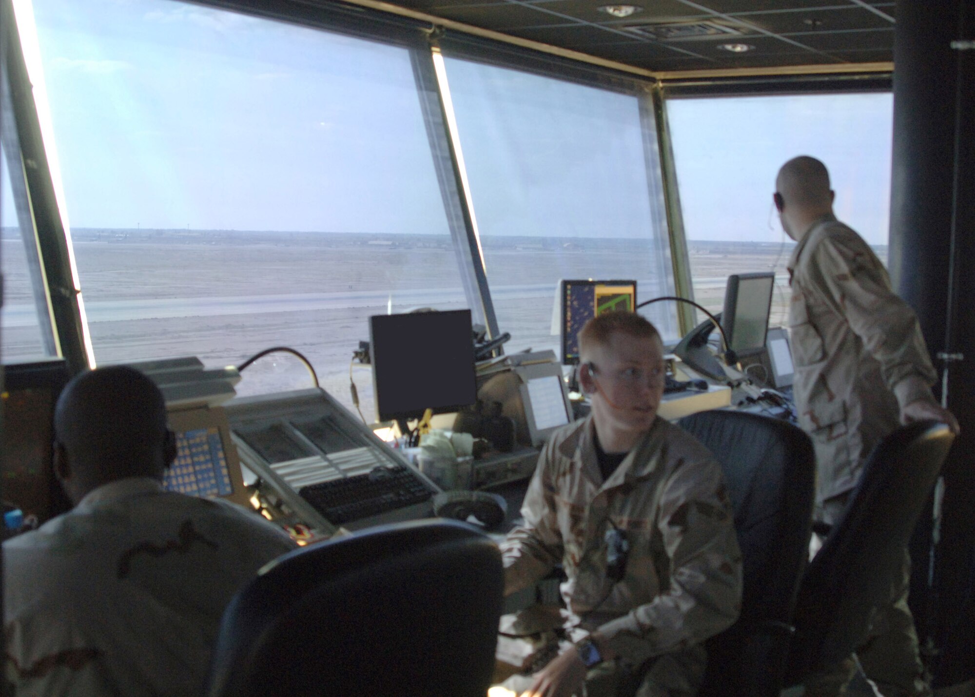 BALAD AIR BASE, Iraq - From left, U.S. Air Force Air Traffic Controllers Senior Airmen Bryan Gibson and Beau Portman and Airman 1st Class Justin Hobgood control the take off an Iraqi Air Force C-130 Hercules loaded with pallets of food, tents and other humanitarian relief supplies for delivery to Iraqis in the city of Tal Afar north of Mosul. Iraqi citizens in Tal Afar were victimized in an insurgent vehicle-borne improvised explosive device attack March 27 that killed 80 Iraqis, wounded 140 more and destroyed more than 20 homes. (U.S. Air Force photo/Capt. Ken Hall)