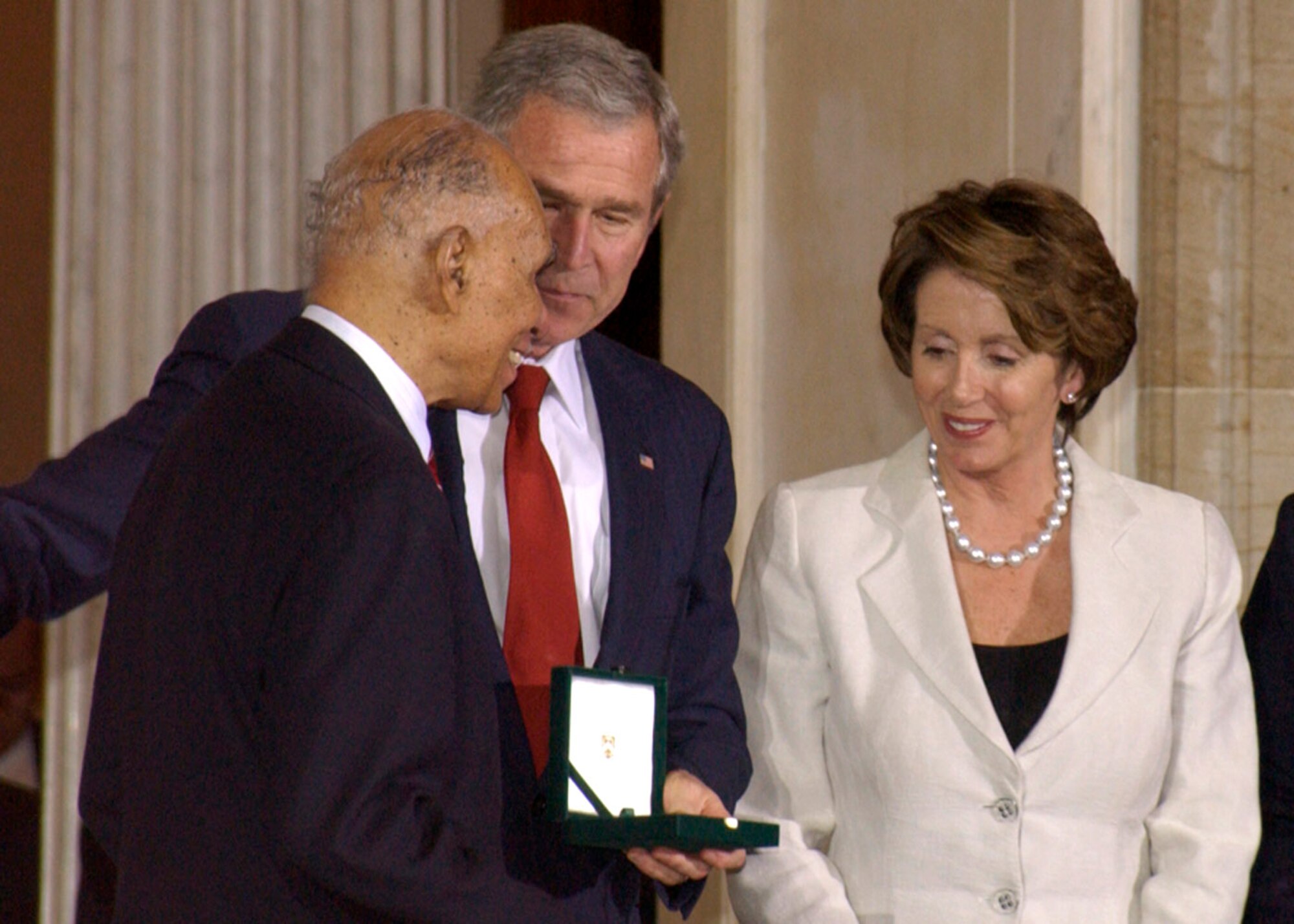 President Bush and Nancy Pelosi, speaker of the U.S. House of Representatives, present Tuskegee Airman Dr. Roscoe Brown Jr. with the Congressional Gold Medal, Congress' most distinguished award. Dr. Brown, along with five other Tuskegee Airmen, accepted the award on behalf of the more than 300 Airmen in attendance at the ceremony. (U.S. Air Force photo/Faith Harris)  
 
