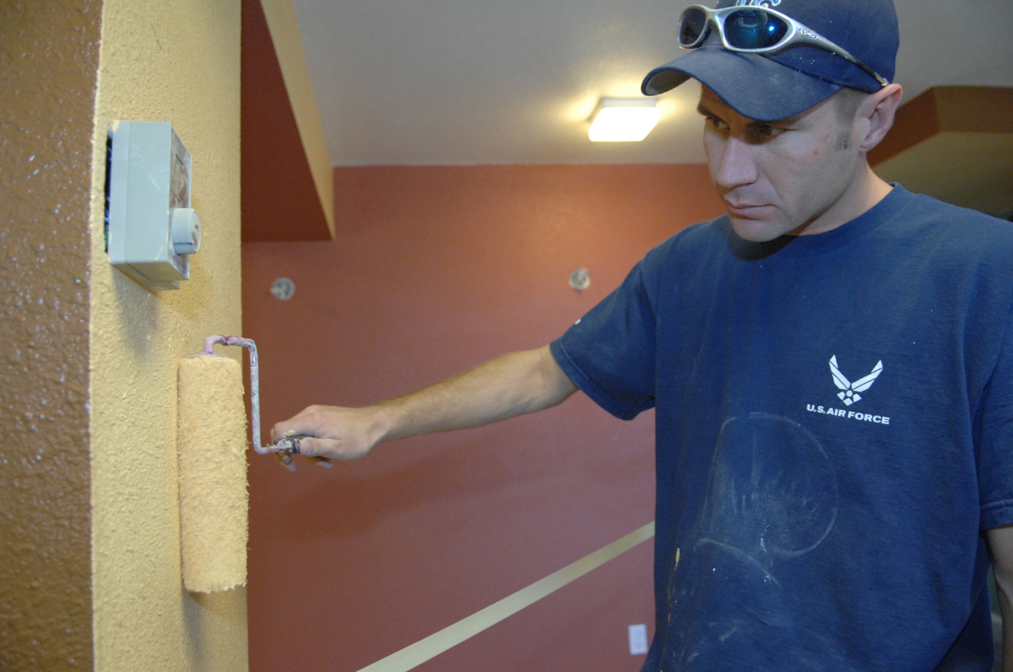 Tech. Sgt. Mark Kerr, a structures craftsman with the 99th Civil Engineer Squadron, puts the finishing touches of paint on a wall inside of the up-comming Airmen's Center. Sergeant Kerr is the head project manager for the Airmen's Center and along with the help of volunteers from across the base, they've been working non-stop for 10 months. 
(U.S Air Force Photo/Senior Airman Larry E. Reid Jr.) 
