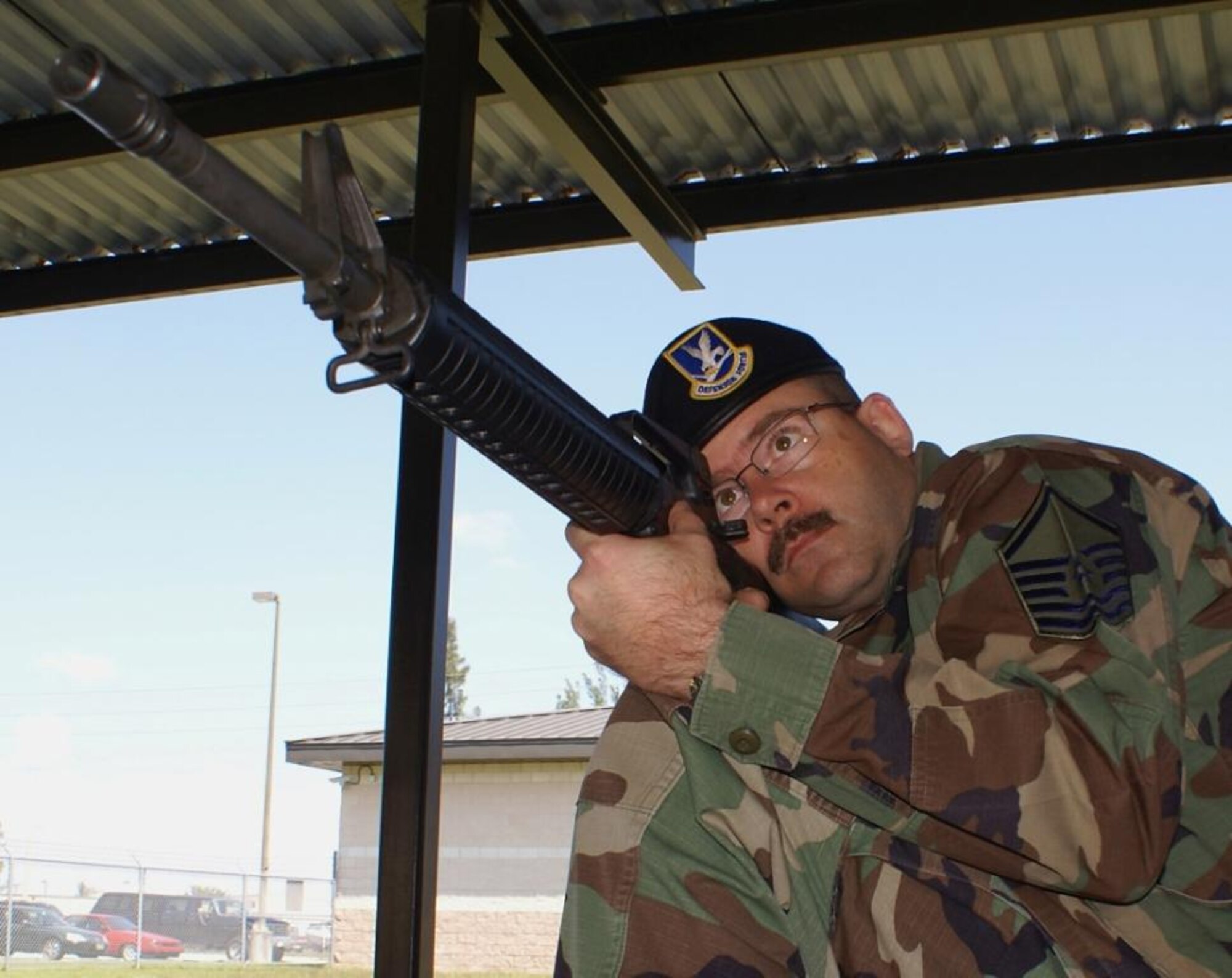 Master Sgt. Stephen Hodges, 482nd Security Forces Squadron, demonstrates the kneeling position used during the Elementary Excellence in Competition Rifle Match at Wright-Patterson A.F.B, Ohio. Shooters had 45 seconds to shoot ten rounds each in the kneeling, standing, and sitting positions. They had one minute to shoot 20 rounds in the prone, or lying down, position. (U.S. Air Force photo/Dan Galindo)