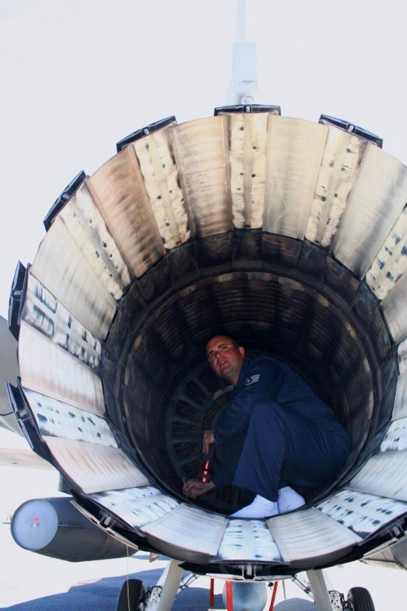 Staff Sgt. Justin Mollahan cleans a heat sensor in the engine of an F-16 Fighting Falcon March 26 at Avalon Airport in Victoria, Australia. Pacific Air Forces Airmen and aircraft showcased American air power at the Australian International Airshow '07. Sergeant Mollahan is an engine specialist with the 35th Aircraft Maintenance Squadron at Misawa Air Base, Japan. (U.S. Air Force photo/Capt. Yvonne Levardi)