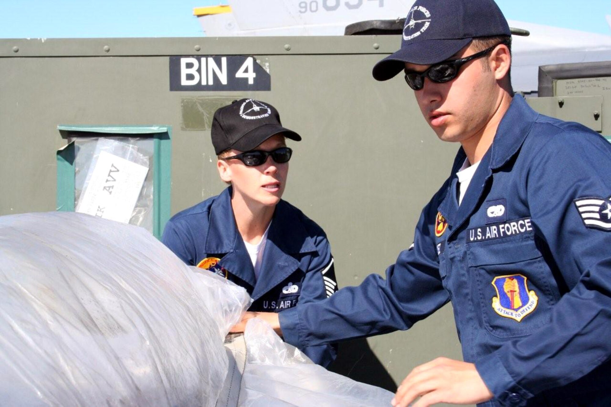 Master Sgt. Renee Miller and Staff Sgt. Adan Gomez secure a pallet for transport March 26 at Avalon Airport in Victoria, Australia. Pacific Air Forces Airmen and aircraft showcased American air power at the Australian International Airshow '07. Sergeant Miller is the demo team superintendent and Sergeant Gomez is an avionics technician. Both are assigned to the 35th Aircraft Maintenance Squadron at Misawa Air Base, Japan. (U.S. Air Force photo/Capt. Yvonne Levardi)
