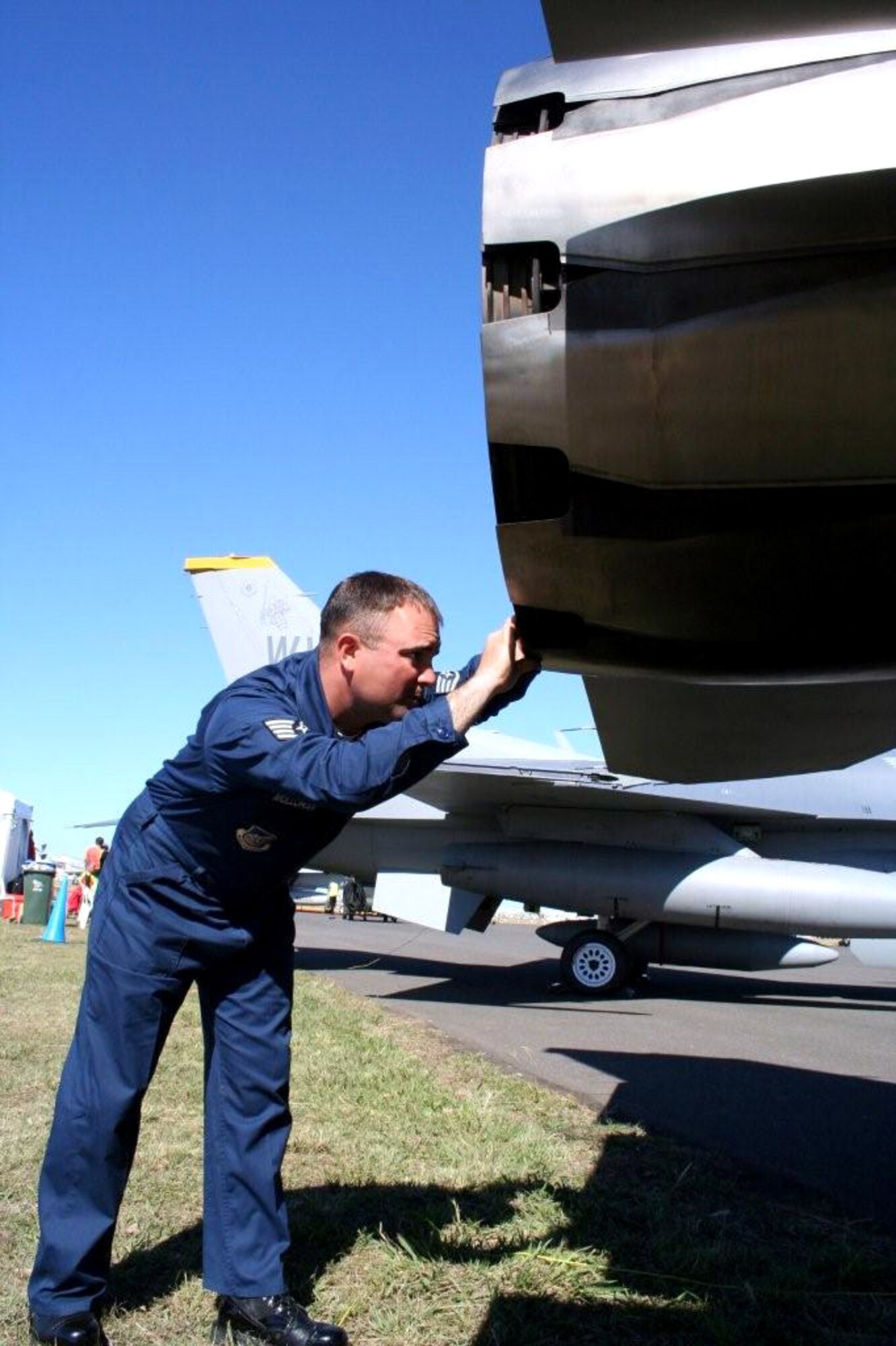 Staff Sgt. Justin Mollahan checks out the engine on an F-16 Fighting Falcon March 26 at Avalon Airport in Victoria, Australia. Pacific Air Forces Airmen and aircraft showcased American air power at the Australian International Airshow '07. Sergeant Mollahan is an engine specialist with the 35th Aircraft Maintenance Squadron from Misawa Air Base, Japan. (U.S. Air Force photo/Capt. Yvonne Levardi)
