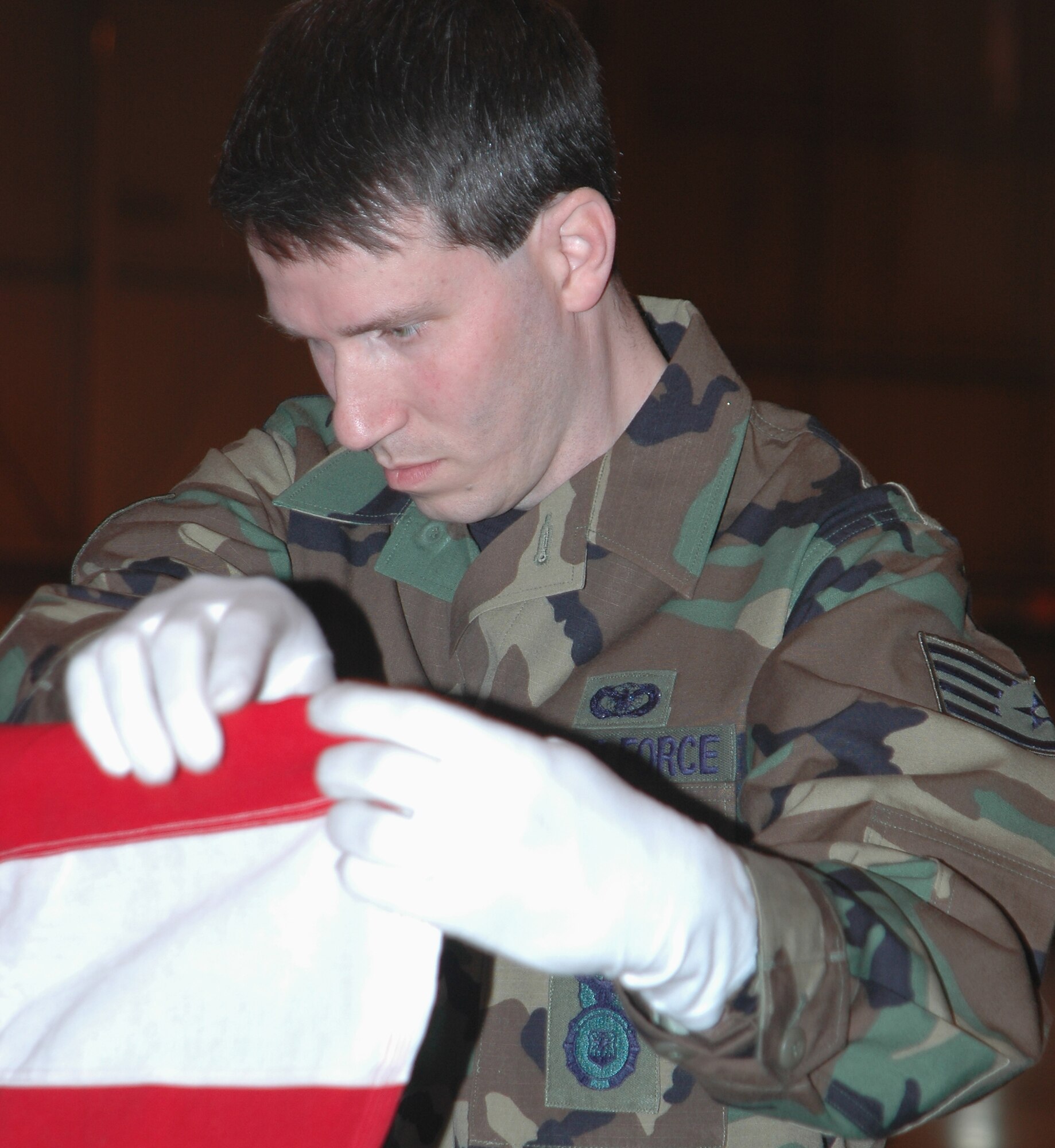 GRISSOM AIR RESERVE BASE, Ind., -- Staff Sgt. Benjamin Durr, 434th Security Forces Squadron, folds a flag during a mock funeral service as part of a graduation ceremony and induction into the Grissom Honor Guard. Six new members completed training and were inducted into the Honor Guard March. 30. (U.S. Air Force photo/Tech. Sgt. Doug Hays)