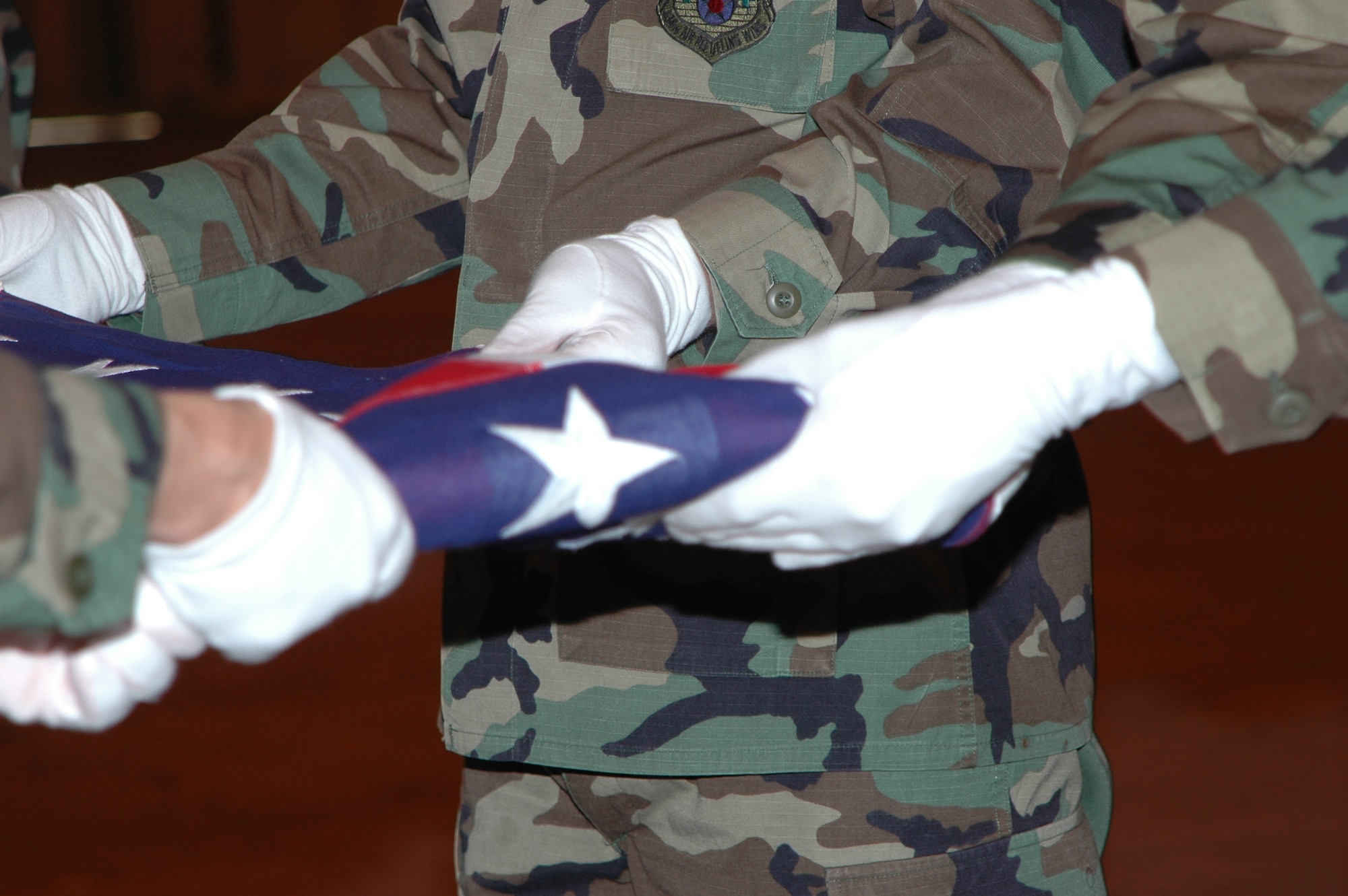 GRISSOM AIR RESERVE BASE, Ind., -- Members of the Grissom Honor Guard make the final folds on the flag during a mock funeral service culminating their training and induction into the Honor Guard. Six new members completed training and were inducted into the Honor Guard March. 30. (U.S. Air Force photo/Tech. Sgt. Doug Hays)