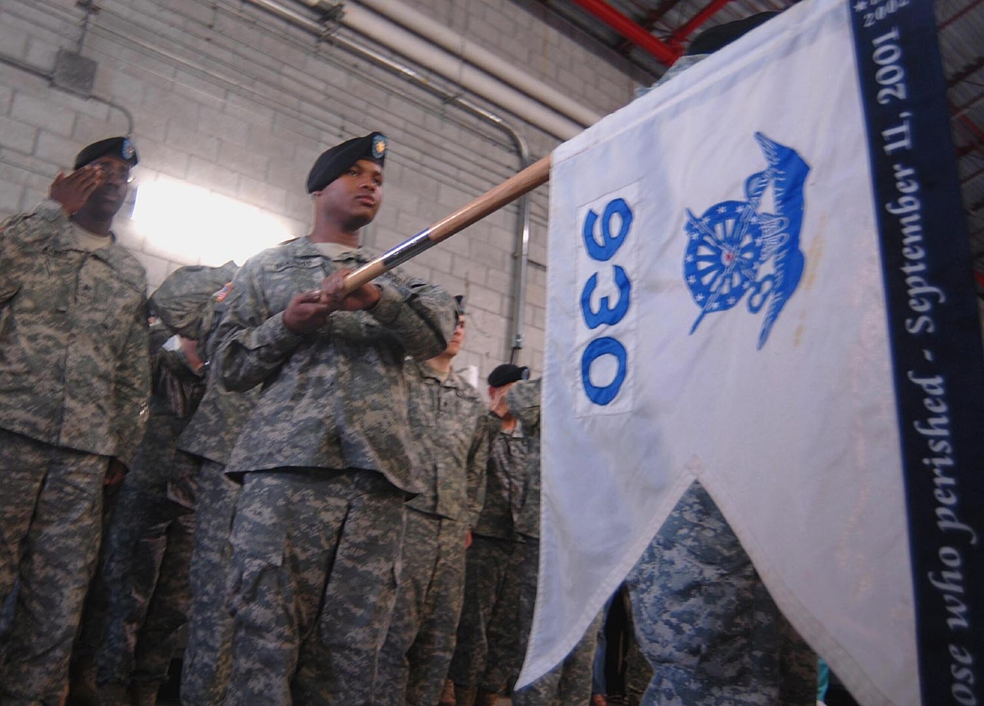 Spc. Tracy Bracyboy of the Florida Army National Guard’s 930th Army Liaison Team presents the unit’s guidon during a welcome home ceremony at the armory of the 50th Area Support Group headquarters Mar 22. Dozens of family members came out to welcome the troops back after spending a year deployed to Afghanistan. (U.S. Air Force photo/Staff Sgt. Thomas Kielbasa)