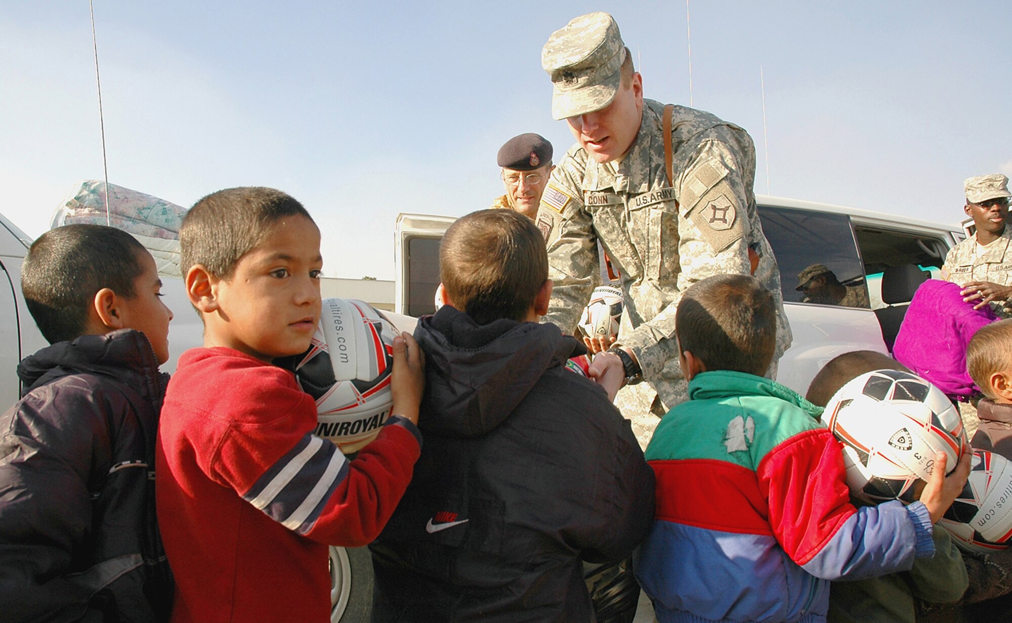 Orphans at the Allhoddin orphanage is Kabul, Afghanistan, line up for soccer balls and blankets on Nov. 30, 2006 from Lt. Col. Abe Conn, 930th ALT. While deployed, the unit took the time to organize the collection of donations from across the U.S. The soldiers handed out nearly 2,000 blankets, 1,000 balls and basic school supplies. (U.S. Air Force photo/Tech. Sgt. Christopher DeWitt)