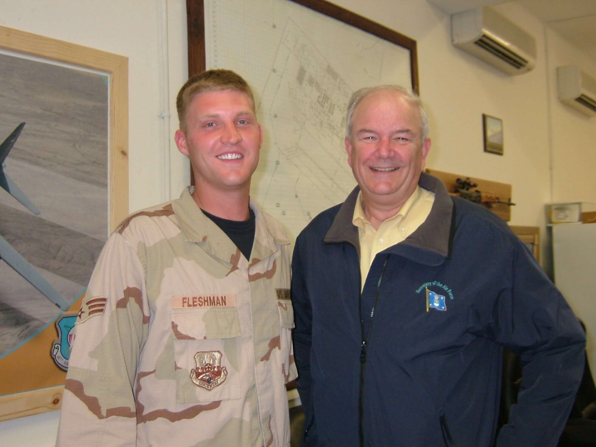 ALI BASE, Iraq – Senior Airman Timothy Fleshman, deployed from RAF Lakenheath to the 407th Air Expeditionary Group, is pictured here with the secretary of the Air Force March 28. The Honorable Michael Wynne toured 407th AEG facilities and dined with some of the unit’s top Airmen. Airman Fleshman is a vehicle maintenance technician with the 48th Logistics Readiness Squadron. (U.S. Air Force photo)