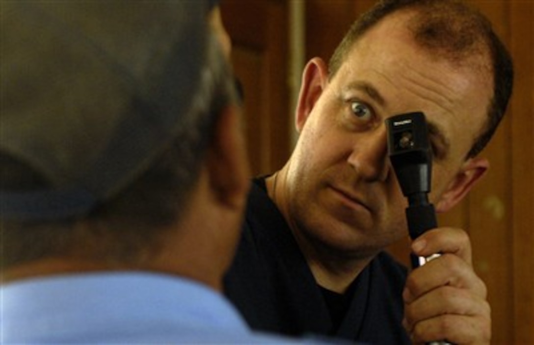 Lt. Col. John Blackburn examines a Nicaraguan volunteer policeman's eyes March 19 at a makeshift optometry clinic at Collegio San Gregorio. Inside the local school, 836 Nicaraguan patients were given free medical, dental and optometry care during New Horizons-Nicaragua 2007.