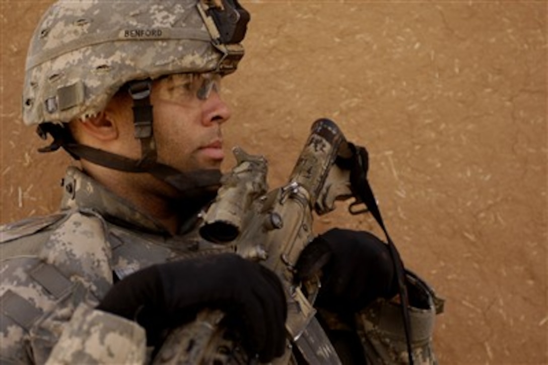 U.S. Army Sgt. David Benford provides security during an Iraqi police lead search in Qarah Cham village, Iraq, with the Iraqi Emergency Services Unit on March 27, 2007.  Benford is assigned to Headquarters and Headquarters Company, 2nd Battalion, 27th Infantry Regiment, 3rd Brigade Combat Team, 25th Infantry Division.  