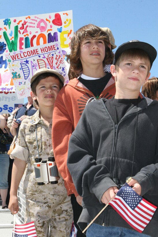 MARINE CORPS AIR STATION MIRAMAR, Calif. ? Logan Polson, 6, stands behind his older brothers, Austin, 10, and Drew, 14, while waiting for his father, Capt. Jeff Polson, headquarters company commander, Marine Wing Support Squadron 373, to turn in his rifle after returning home from deployment March 30.